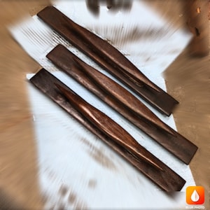 May include: Three wooden drawer pulls with a curved design. The pulls are dark brown and have a smooth finish.