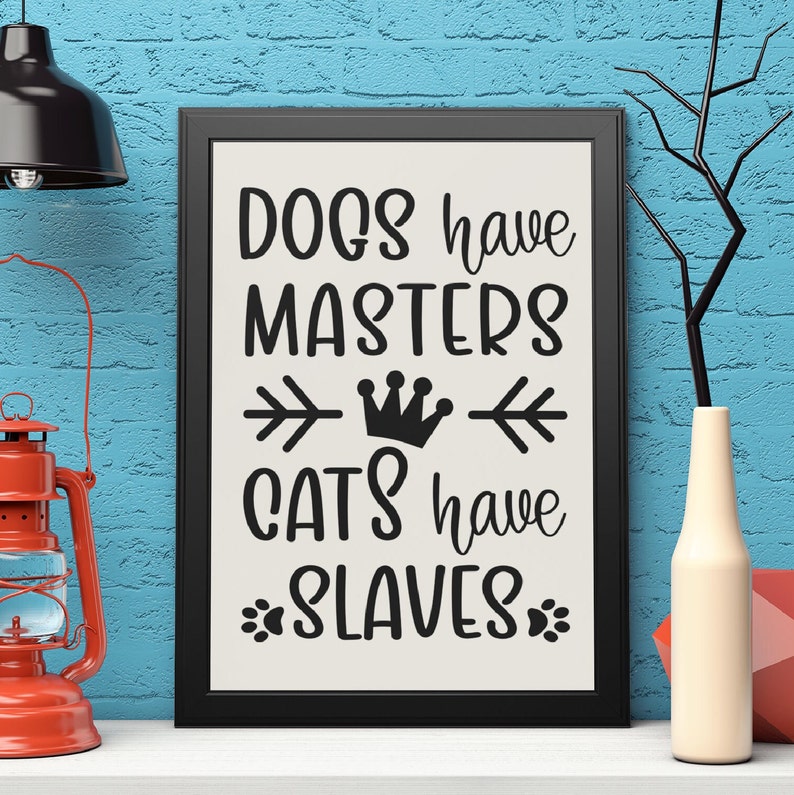May include: Black and white sign with the text "Dogs have masters, cats have slaves" with a crown and arrows in between the words.