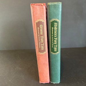 May include: Two hardcover books, one red and one green, with gold lettering on the spines. The red book is titled "Grimms' Fairy Tales" and the green book is titled "Andersen's Fairy Tales".
