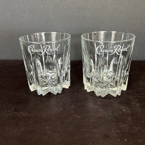 May include: Two clear glass Crown Royal whiskey tumblers with a cut glass design.