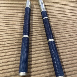 May include: Two silver and blue metal sticks with a textured surface. The sticks are about 12 inches long.