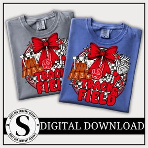 May include: Two t-shirts, one gray and one blue, feature a vibrant graphic design. The design includes a red bow, a foam finger, and the words "Track & Field" in red. The shirts are labeled "Comfort Colors".