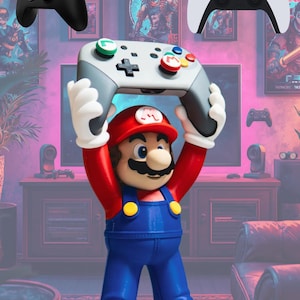 May include: A Mario figurine wearing a red hat with an M emblem, red shirt, and blue overalls, holding a gray and white game controller with green L and red M buttons above its head, flanked by a black Xbox controller and a white PS5 controller.