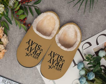 May include: A pair of brown fuzzy slippers with the text "When we pray we slay" printed on them.