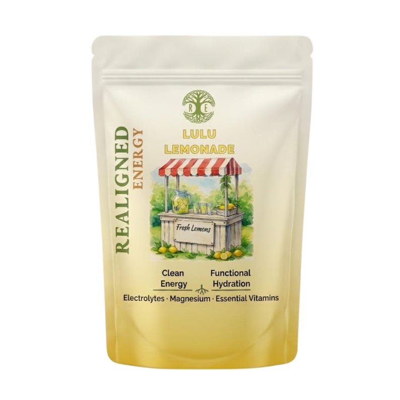 May include: A white pouch with the text "REALIGNED ENERGY" and "LULU LEMONADE". The pouch features an illustration of a lemonade stand with lemons. Additional text includes "Clean Energy", "Functional Hydration", "Electrolytes", "Magnesium", and "Essential Vitamins".