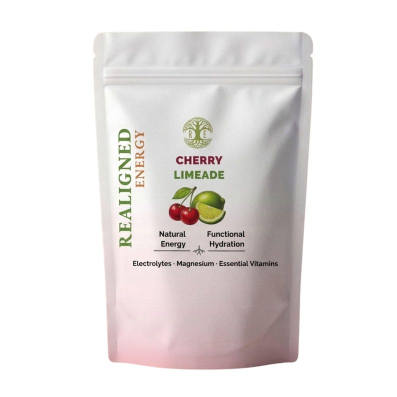 May include: White pouch with the text "REALIGNED ENERGY" in green and "CHERRY LIMEADE" in red and green. The pouch features illustrations of cherries and a lime, with text indicating natural energy and functional hydration.
