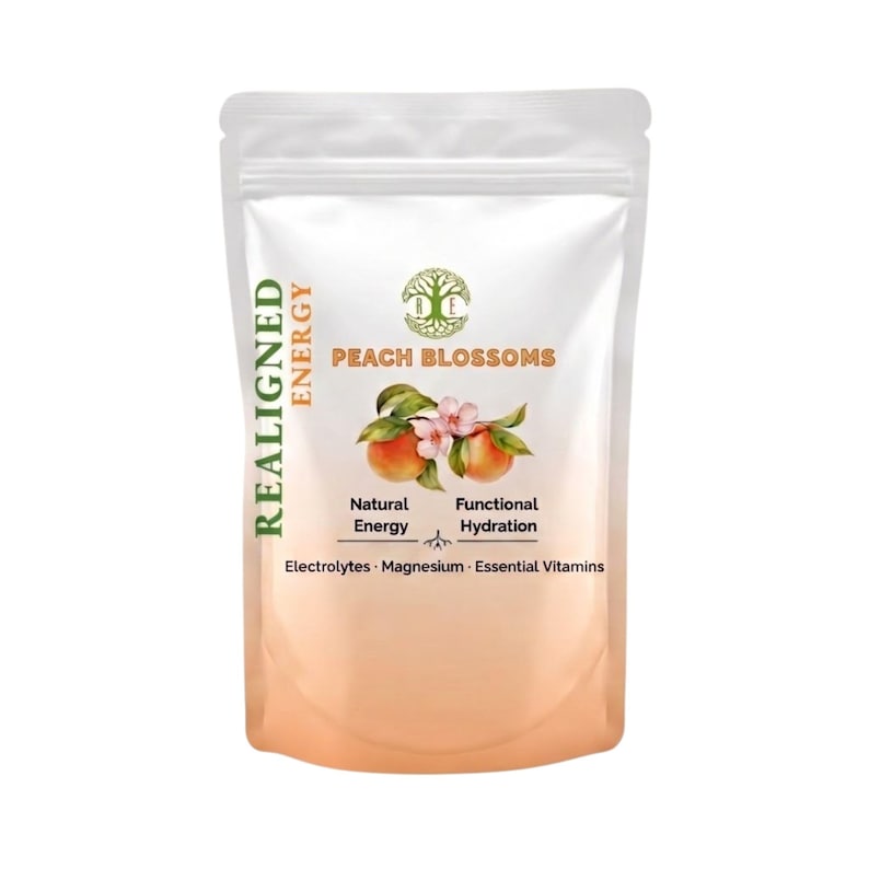 May include: A white pouch of Realigned Energy Peach Blossoms. The pouch features a peach and blossom illustration, with text indicating natural energy and functional hydration. The bottom of the pouch has a peach-colored gradient.