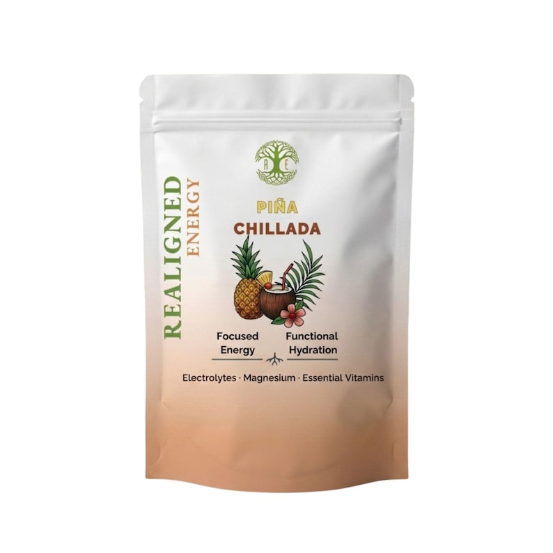 May include: A white pouch with the words "REALIGNED ENERGY" and "PI&Ntilde;A CHILLADA" printed on it. The pouch features a pineapple, coconut, and flower graphic. The text "Focused Energy" and "Functional Hydration" are also visible.