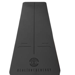 May include: Black yoga mat with alignment lines and the text "REALIGNEDENERGY". The mat features a tree of life logo. The mat is designed for yoga and fitness activities.