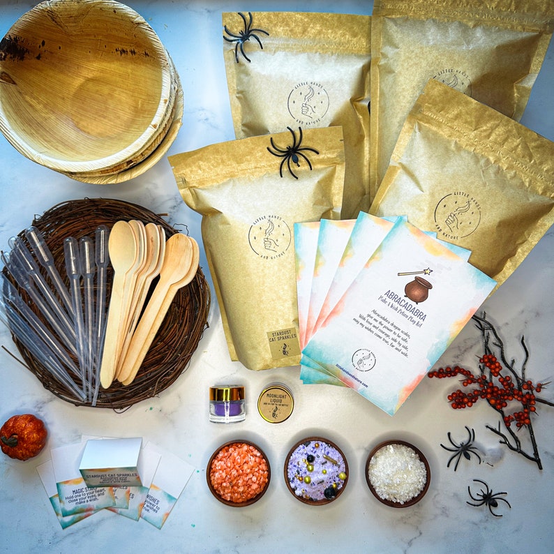 May include: A Halloween-themed party kit with a cauldron, a wand, and a variety of colorful sprinkles. The kit also includes a set of instructions for making a magical potion. The kit is packaged in a brown paper bag with a spider web design.