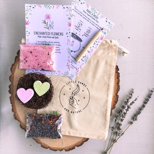 May include: A craft kit for making flower wishes. The kit includes a small bag of pink glitter, two heart-shaped bath bombs, a small bag of dried lavender and rose petals, and two instruction cards with the text "Make a Wish" and "Enchanted Flowers Make a Wish Potion and Spell".