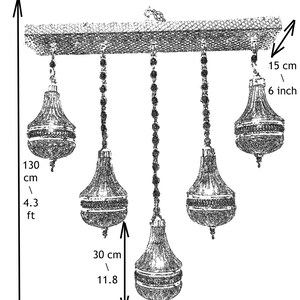 May include: A five-light chandelier with crystal accents. The chandelier is 4.3 feet tall and has a width of 33.5 inches. The chandelier has a chain that is 11.8 inches long and a base that is 9.8 inches wide.