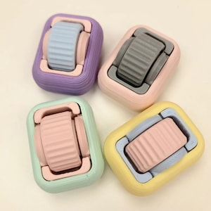 May include: Four colorful fidget toys with a textured wheel in the center. The toys are purple, gray, green, and yellow.