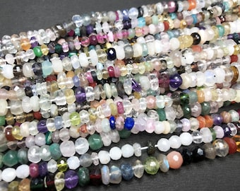 May include: A strand of colorful gemstone beads, featuring a variety of shapes and sizes. The beads are a mix of clear, opaque, and translucent stones, including amethyst, aquamarine, citrine, rose quartz, and more.