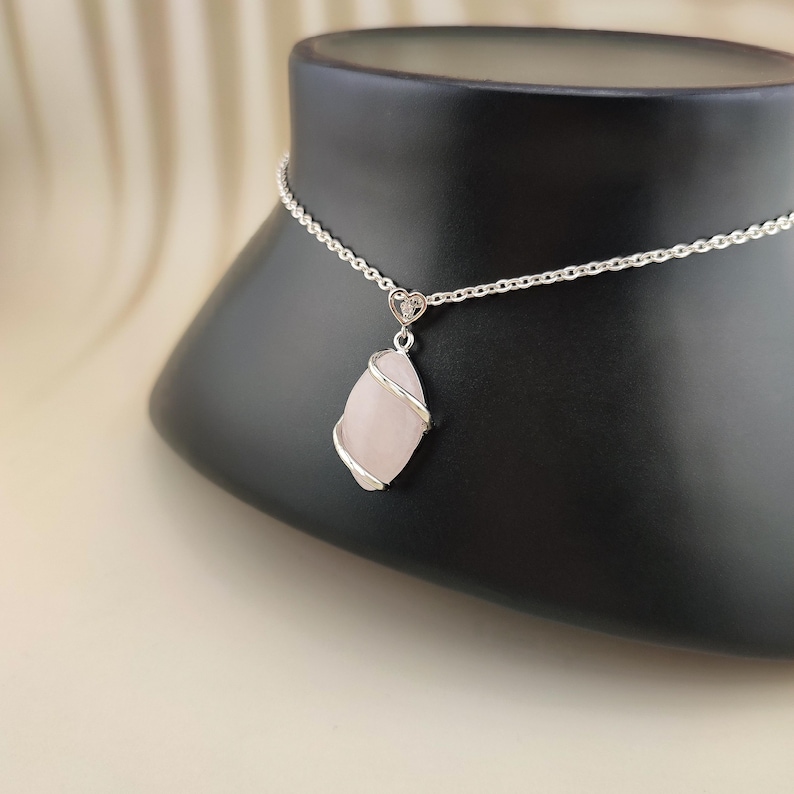 Dainty necklace made with natural rose quartz stone wrapped in elegant silver brass and suspended from a stainless steel chain.