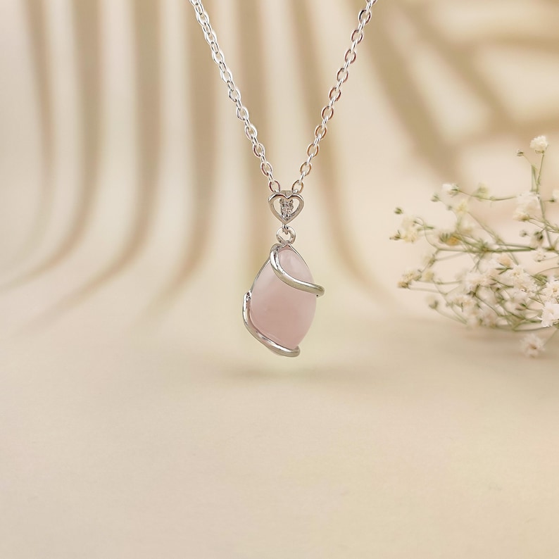 Dainty necklace made with natural rose quartz stone wrapped in elegant silver brass and suspended from a stainless steel chain.