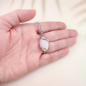 Dainty necklace made with natural rose quartz stone wrapped in elegant silver brass and suspended from a stainless steel chain.