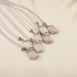 Dainty necklace made with natural rose quartz stone wrapped in elegant silver brass and suspended from a stainless steel chain.