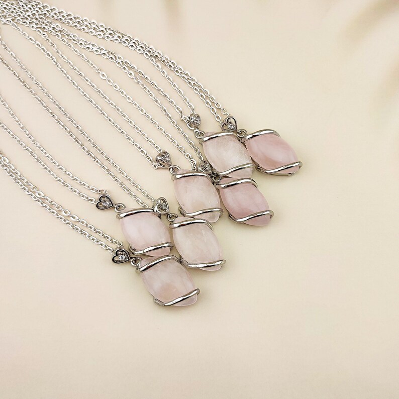 Dainty necklace made with natural rose quartz stone wrapped in elegant silver brass and suspended from a stainless steel chain.