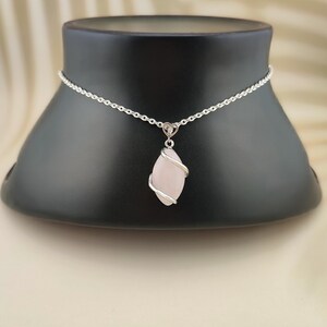 Dainty necklace made with natural rose quartz stone wrapped in elegant silver brass and suspended from a stainless steel chain.