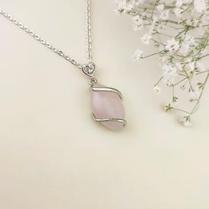 Dainty necklace made with natural rose quartz stone wrapped in elegant silver brass and suspended from a stainless steel chain.