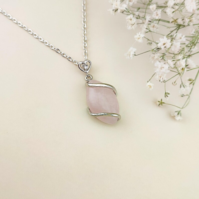 Dainty necklace made with natural rose quartz stone wrapped in elegant silver brass and suspended from a stainless steel chain.