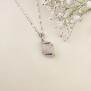 Dainty necklace made with natural rose quartz stone wrapped in elegant silver brass and suspended from a stainless steel chain.