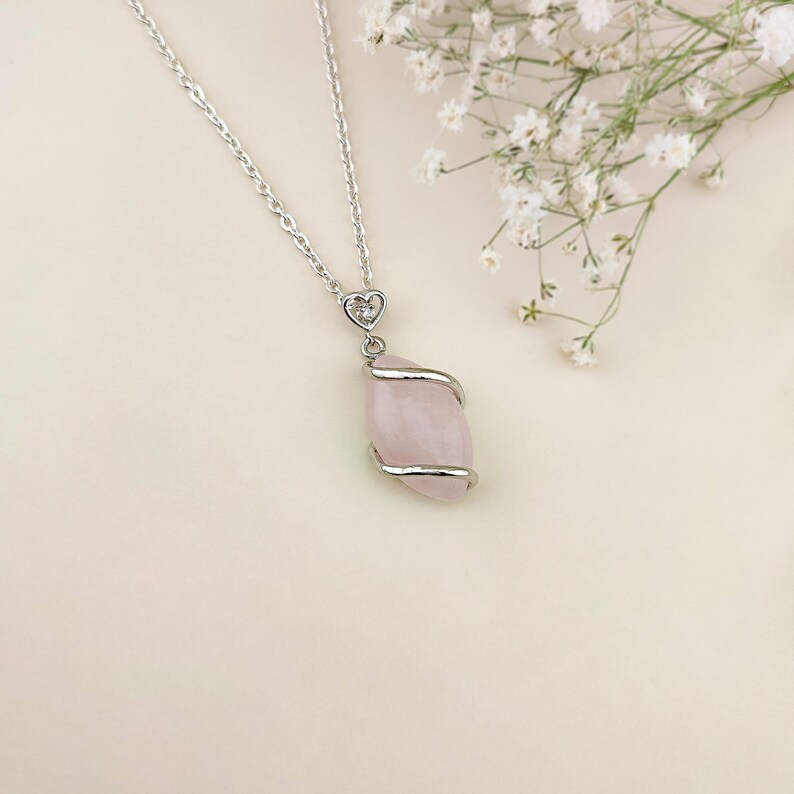 Dainty necklace made with natural rose quartz stone wrapped in elegant silver brass and suspended from a stainless steel chain.
