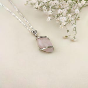 Dainty necklace made with natural rose quartz stone wrapped in elegant silver brass and suspended from a stainless steel chain.