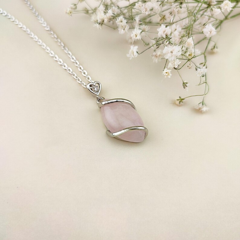 Dainty necklace made with natural rose quartz stone wrapped in elegant silver brass and suspended from a stainless steel chain.