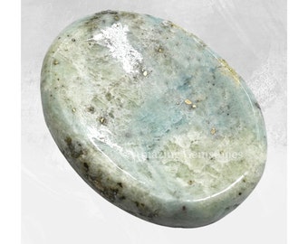 May include: A light blue and green oval-shaped polished stone with a smooth surface and flecks of gold.
