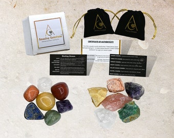 May include: Set of seven chakra healing stones, including amethyst, clear quartz, rose quartz, carnelian, citrine, green aventurine, and lapis lazuli. The stones are arranged in a circle on a light brown surface. The set comes with two black velvet pouches and a card with information about the stones and their corresponding chakras.