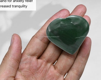 May include: Green heart-shaped stone held in a hand.  Hold in hand for anxiety relief & increased tranquility.