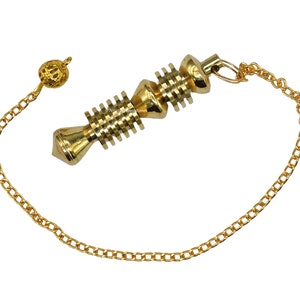 Op de afbeelding: Een gouden metalen slinger met een ketting en een kleine bal aan het uiteinde. De slinger heeft een spiraalvormig ontwerp en wordt gebruikt voor radi&euml;sthesie of waarzeggerij.