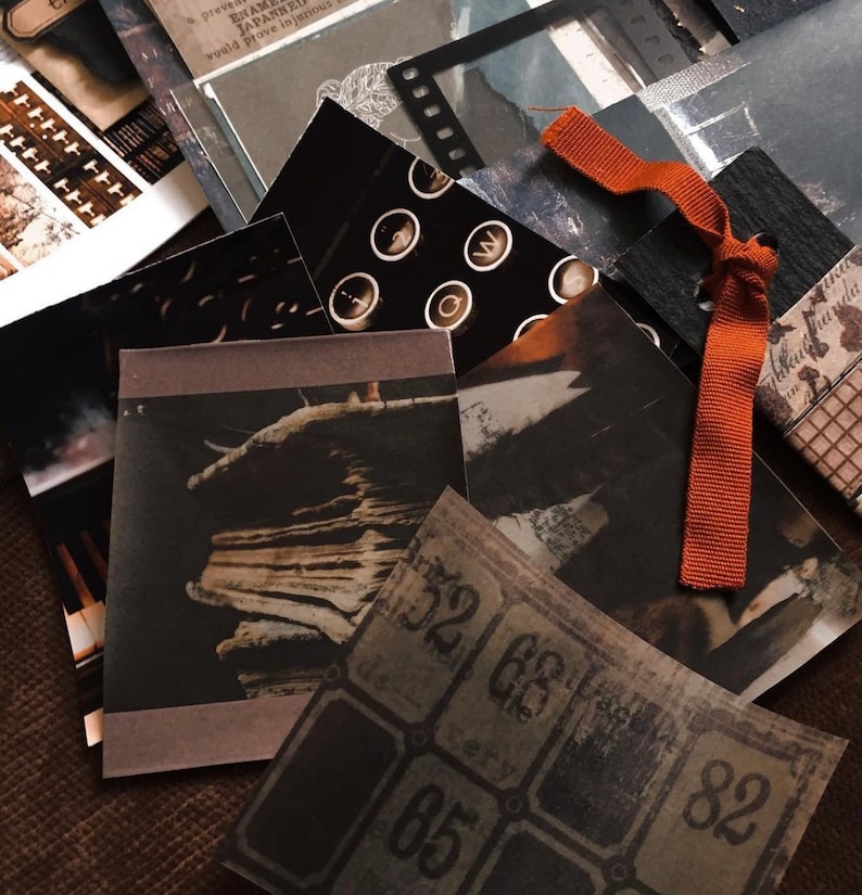 May include: A collection of vintage-style paper ephemera in shades of black, brown, and gray. The assortment includes images of typewriter keys, film strips, and aged tickets. An orange ribbon is tied among the papers, adding a pop of color.