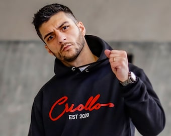 Svart herrhoodie med signatur CRIOLLO-logotyp
