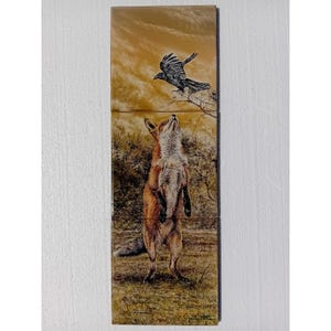 May include: A red fox stands on its hind legs, looking up at a black crow flying overhead. The fox is in a grassy field with trees in the background. The crow is in flight, with its wings spread wide.