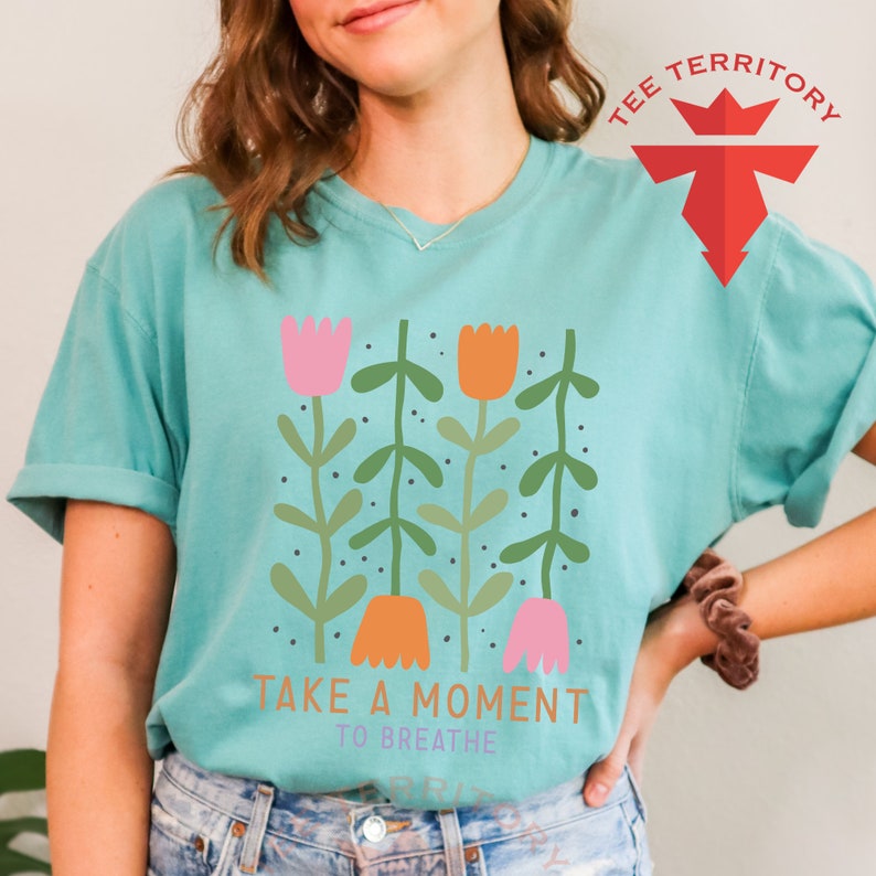 a woman wearing a t - shirt that says take a moment