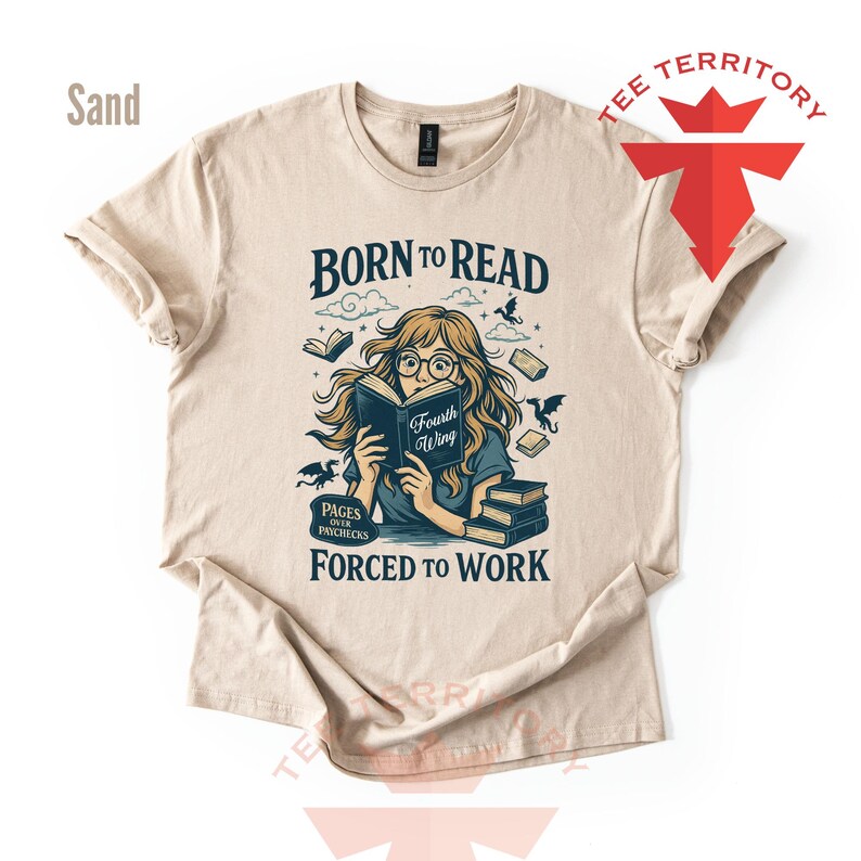 May include: Sand-colored t-shirt with a graphic that reads "Born to Read, Forced to Work." The illustration features a person reading a book with the title "Fourth Wing," surrounded by books and dragons. The shirt has short sleeves.