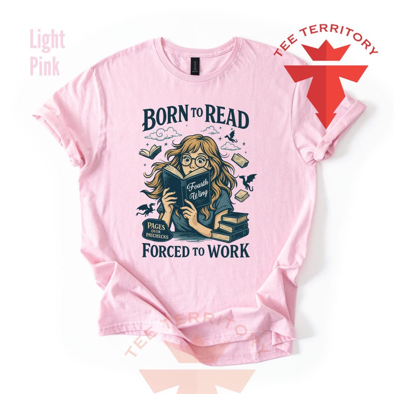 May include: Light pink t-shirt with a graphic of a woman reading a book, surrounded by books and dragons. The text reads "BORN TO READ" above the illustration and "FORCED TO WORK" below. The book reads "Fourth Wing".