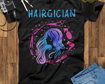 May include: Black t-shirt with the text "HAIRGICIAN" in blue letters. A stylized image of a woman with long hair is surrounded by hairdressing tools and stars.