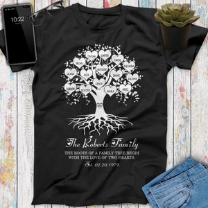 May include: Black t-shirt with a white family tree design. The tree has hearts with names on each branch. The text at the bottom reads "The Roberts Family. The roots of a family tree begin with the love of two hearts. Est. 02.20.1979."