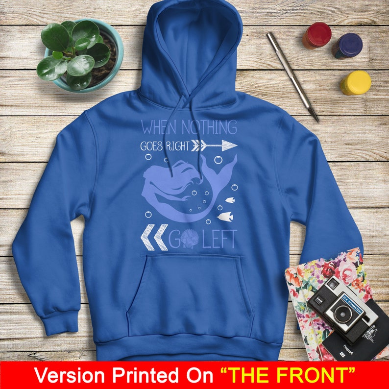 May include: A royal blue hoodie with a white graphic of a mermaid swimming to the left with the text "When nothing goes right go left".