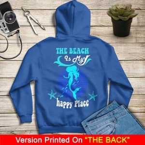 Peut inclure: Un sweat &agrave; capuche bleu royal avec un motif de sir&egrave;ne et le texte "The Beach is My Happy Place".