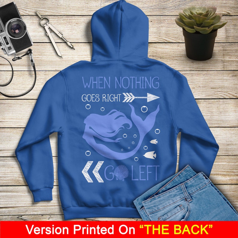 May include: Blue hoodie with a white graphic of a mermaid with the text "When nothing goes right, go left" and an arrow pointing to the right.