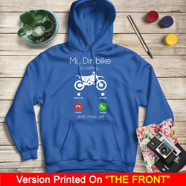 May include: A royal blue hoodie with a white graphic of a dirt bike with a phone icon. The text on the graphic reads "My Dirtbike is calling... and I must go!"