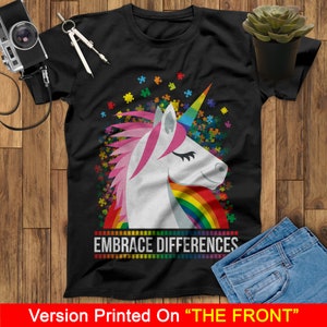 May include: Black t-shirt with a rainbow unicorn and puzzle pieces. The text "Embrace Differences" is printed below the unicorn.