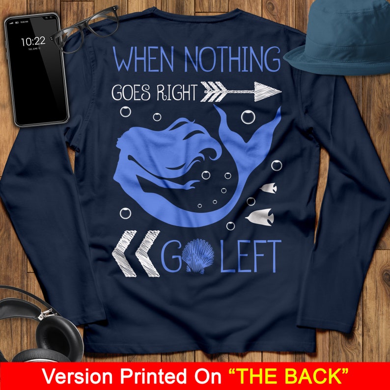 May include: Navy blue long-sleeve shirt with a white mermaid graphic and the text "When nothing goes right, go left".