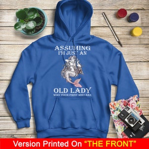 May include: A royal blue hoodie with a white graphic of a mermaid with the text "Assuming I'm just an old lady was your first mistake."