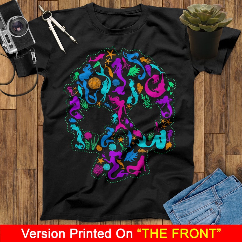 May include: A black t-shirt with a colorful mermaid skull design. The skull is made up of mermaids, seahorses, starfish, and other ocean-themed imagery.